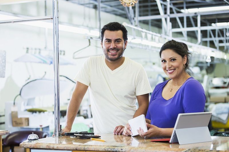 hispanic small business owners dry cleaner paying bills m